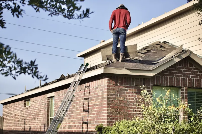 Professional roofer working on a residential roof in Near North Side